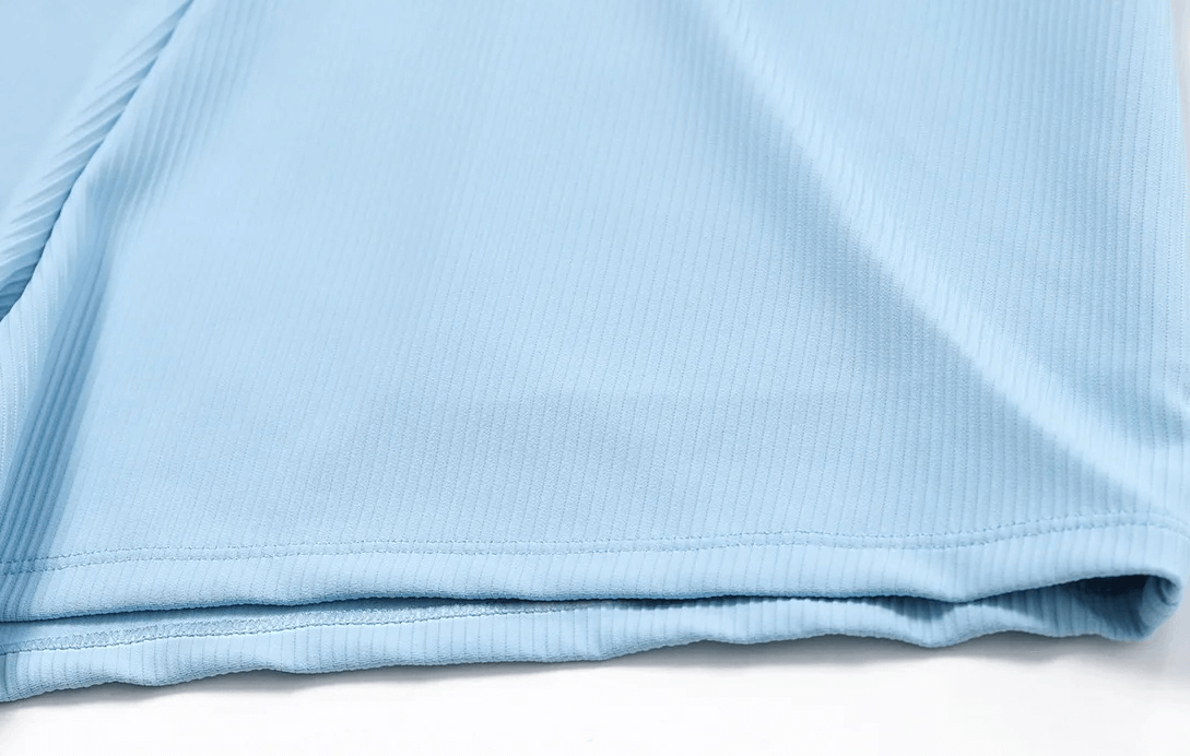 Close-up of blue ribbed fabric from high waist workout shorts, highlighting texture and quality.
